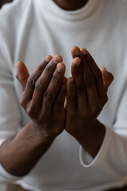 Close-up of a person's hands in a prayer pose, symbolizing gratitude
